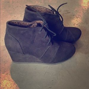 Black wedge lace up booties.